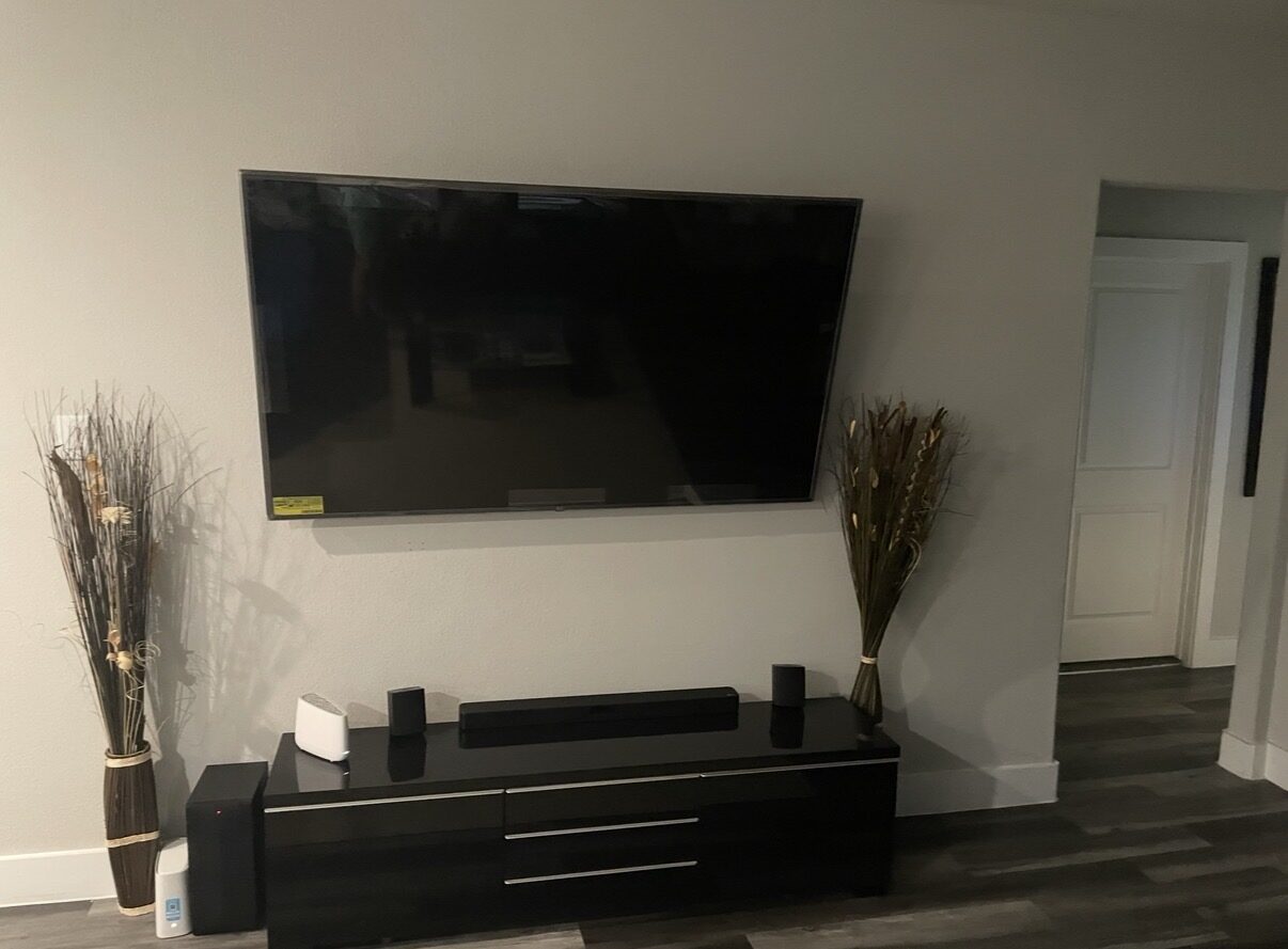 Wall-mounted TV above a media stand